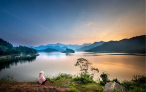 A lady enjoying isolation in front of a beautiful landscape