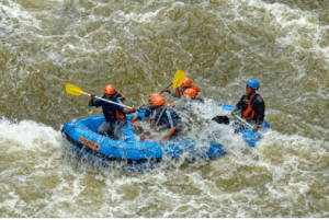 River rafting by the ecotourists in a roaring river.