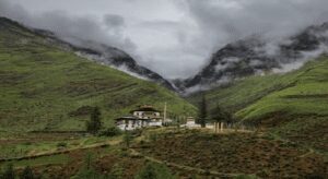 How to Discover Inspiring Eco-Friendly Travel Destinations in 2026? A picturesque monastery nestled in the mountains, with fluffy clouds drifting above, creating a peaceful atmosphere.